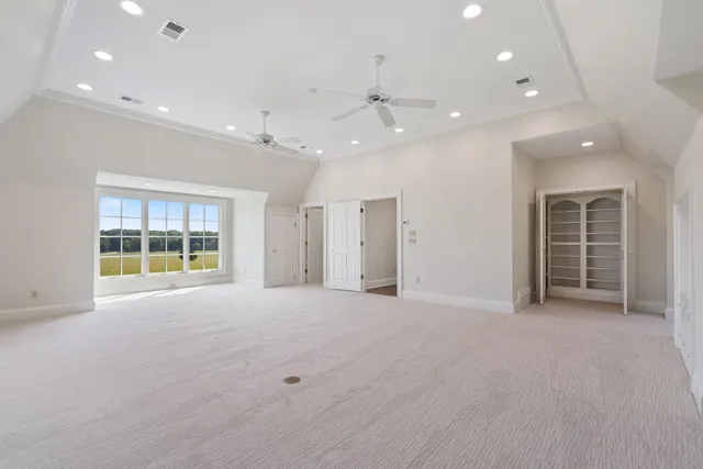 a view of a house with a yard and potted plants