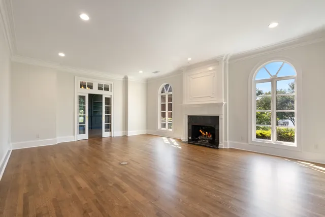 a view of a room with wooden floor and windows