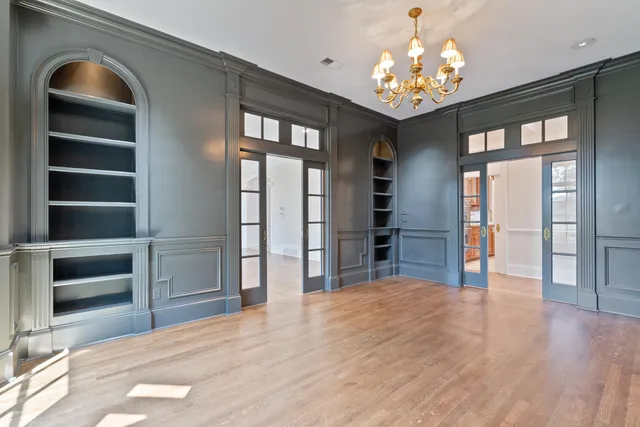 a open kitchen with granite countertop a refrigerator oven a stove and a wooden floors