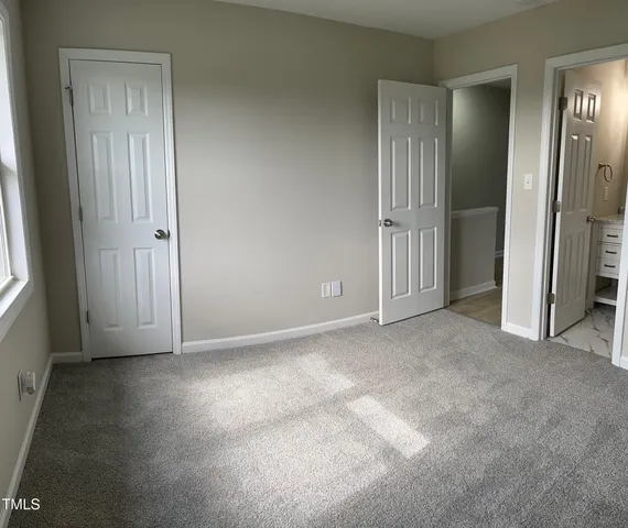 an empty room that has a mirror in it