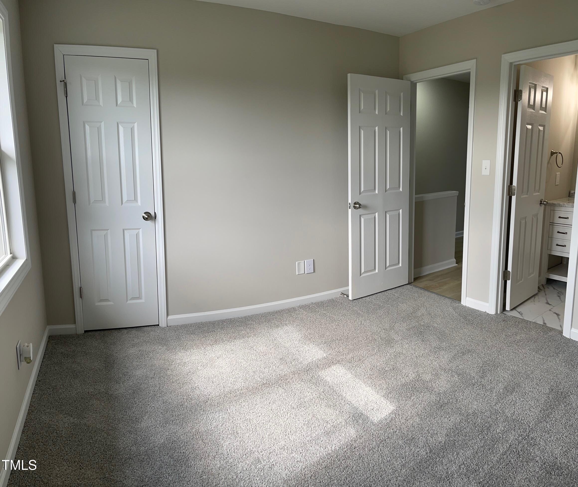 351 East Williams Street Angier, NC 27501 - Photo 14 of 24 an empty room that has a mirror in it