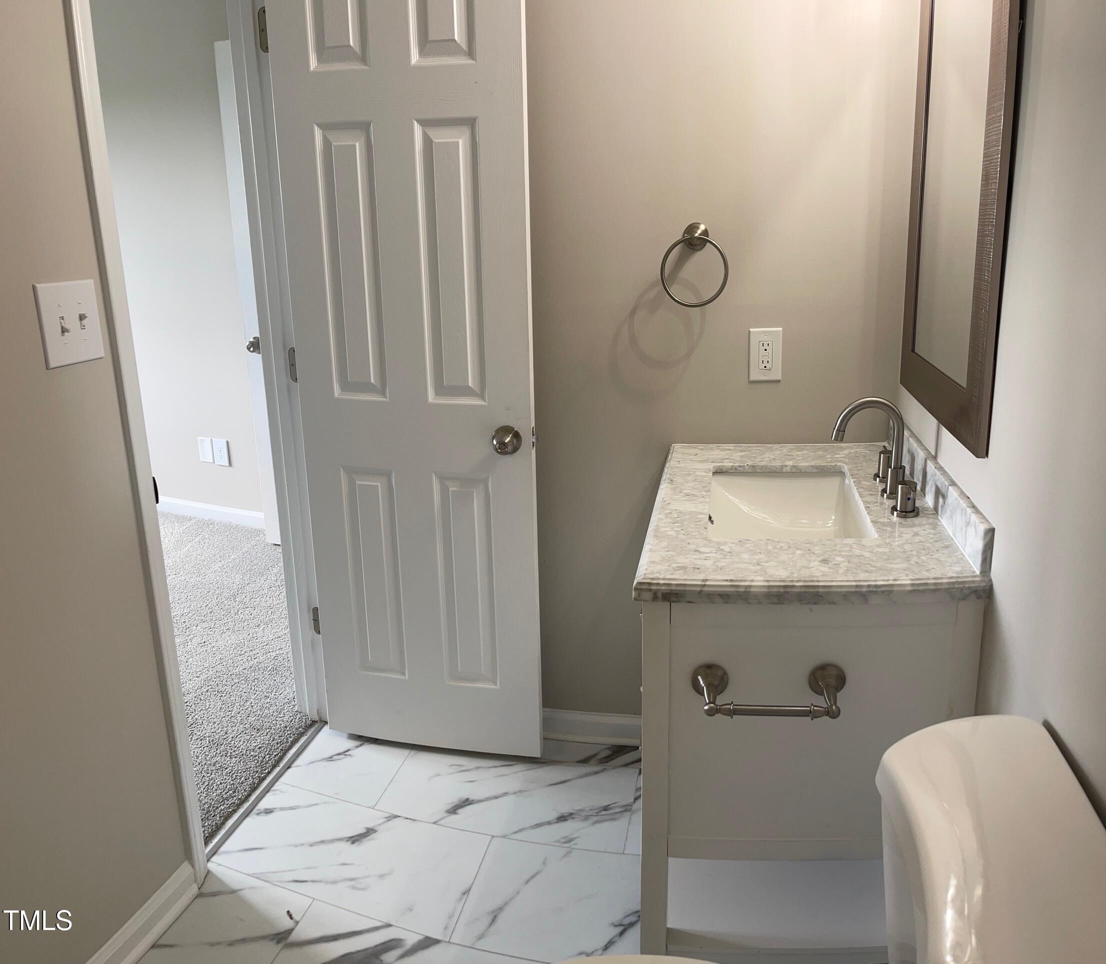 351 East Williams Street Angier, NC 27501 - Photo 15 of 24 a bathroom with a sink toilet and vanity