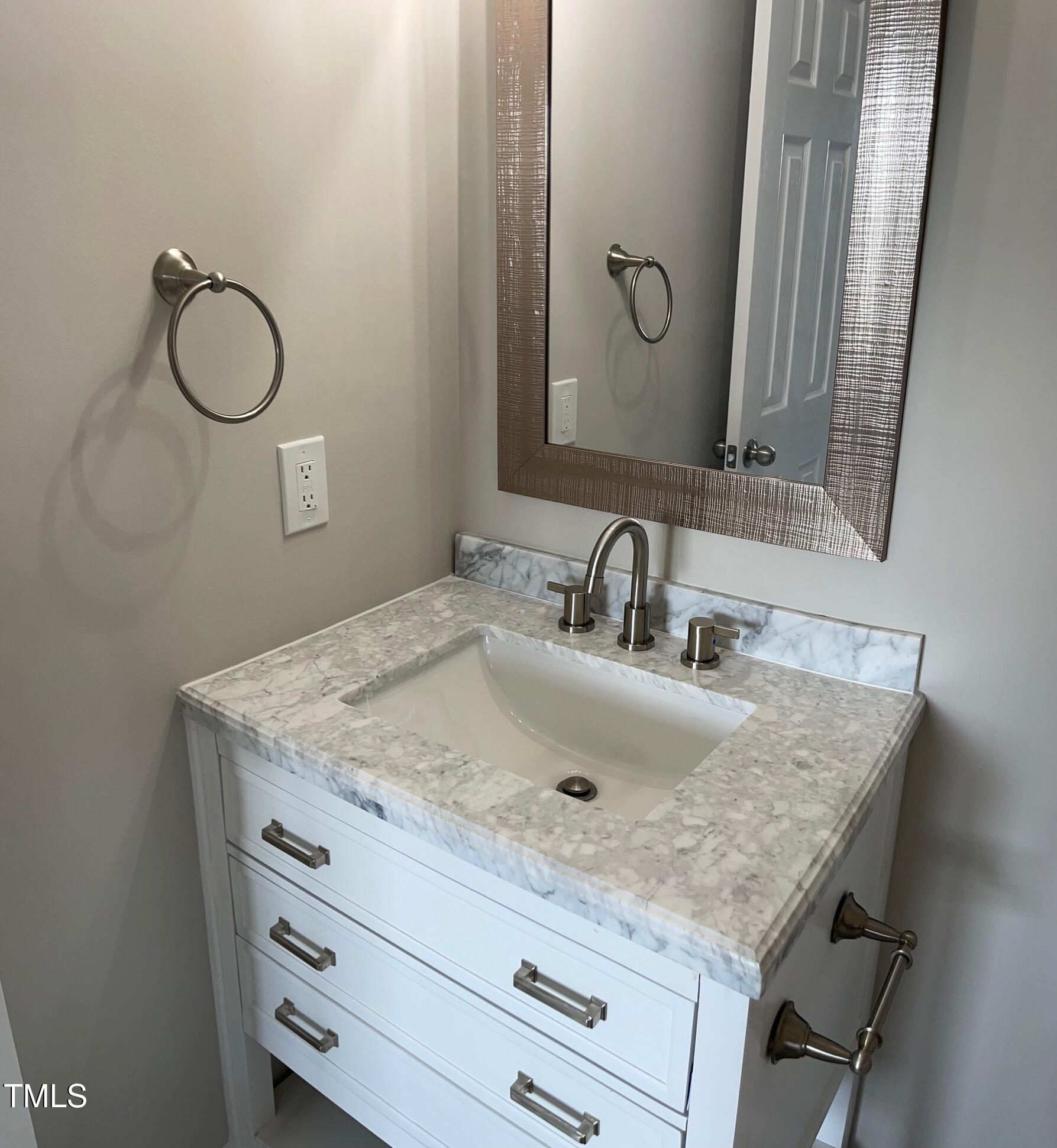 351 East Williams Street Angier, NC 27501 - Photo 18 of 24 a bathroom with a granite countertop sink and a mirror