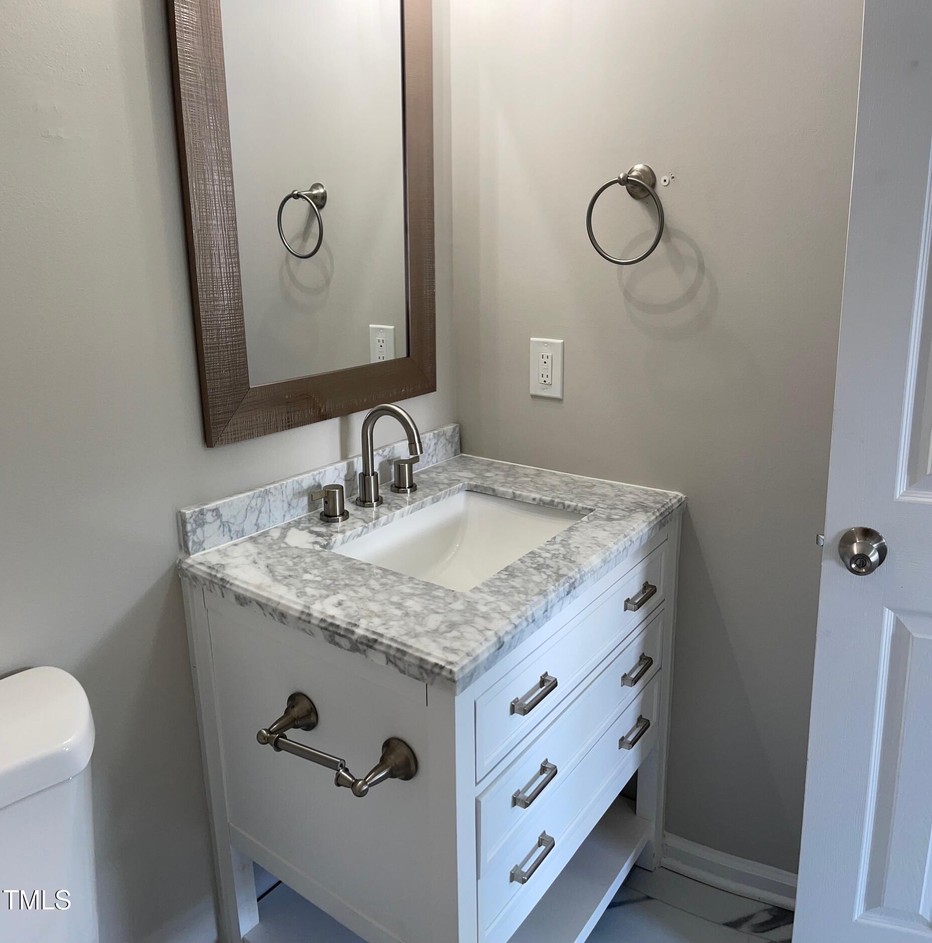 351 East Williams Street Angier, NC 27501 - Photo 22 of 24 a bathroom with a granite countertop sink and a mirror