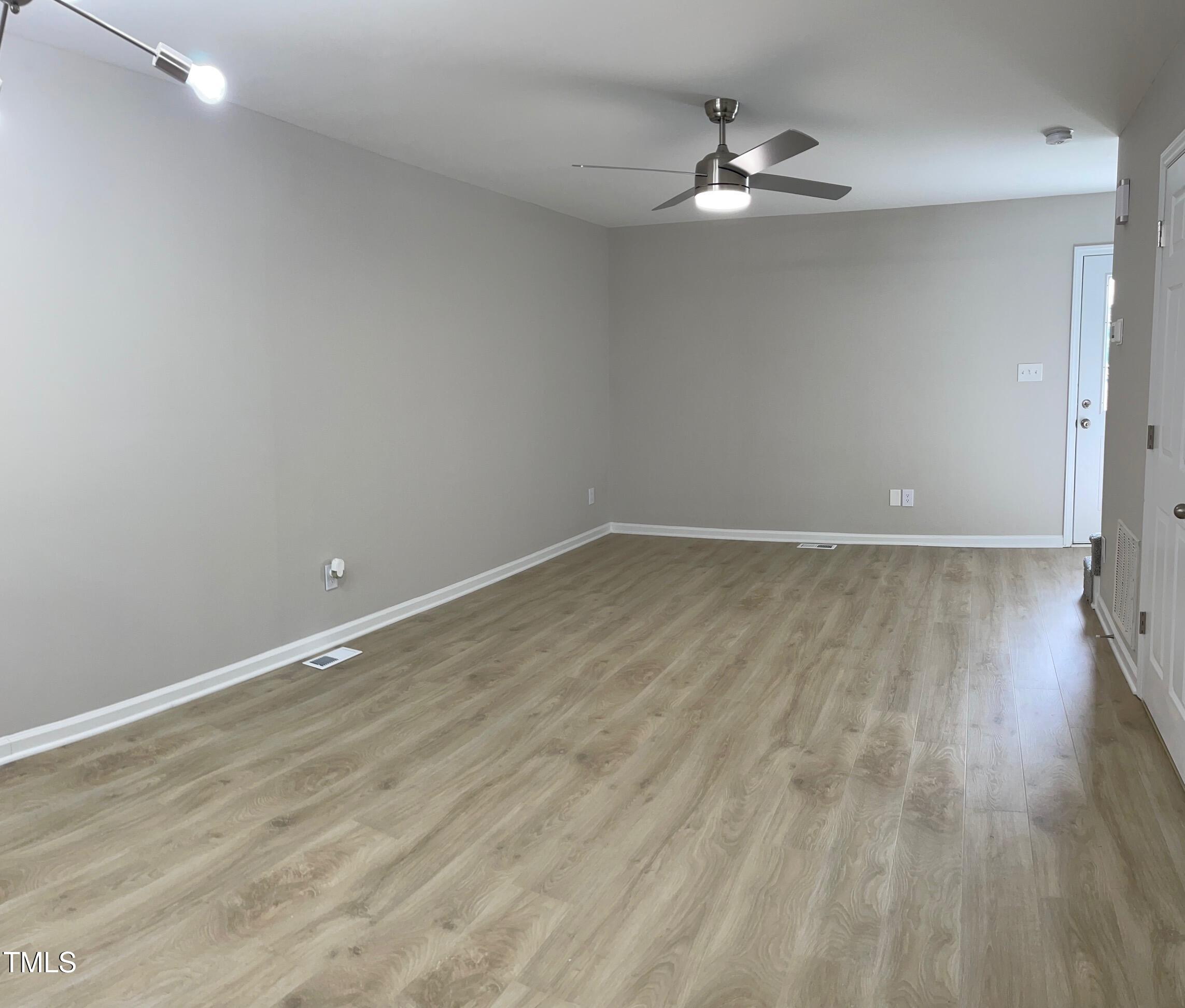 351 East Williams Street Angier, NC 27501 - Photo 3 of 24 wooden floor in an empty room with a window