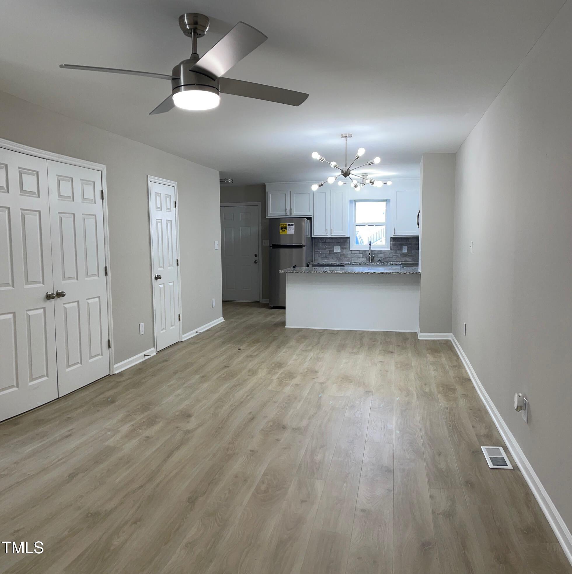 351 East Williams Street Angier, NC 27501 - Photo 6 of 24 a view of a kitchen with a sink dishwasher a kitchen island with wooden floor