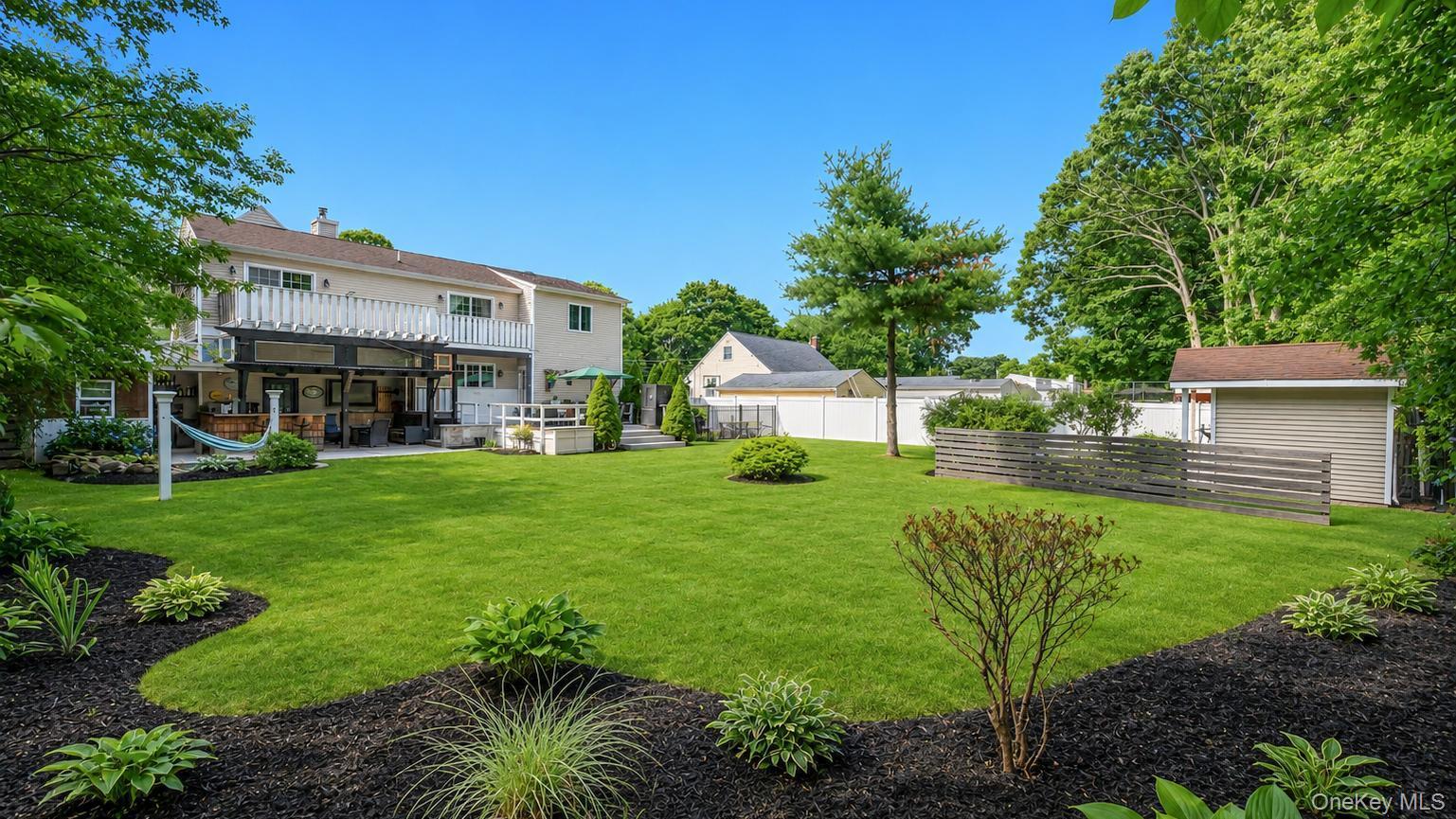 19 Joan Road Bay Shore, NY 11706 - Photo 45 of 50 Expansive green lawn with mature perimeter trees