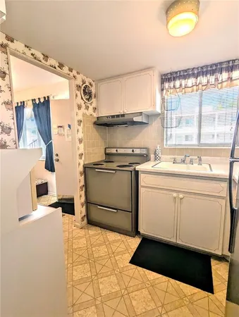 a kitchen with a stove a sink and a refrigerator
