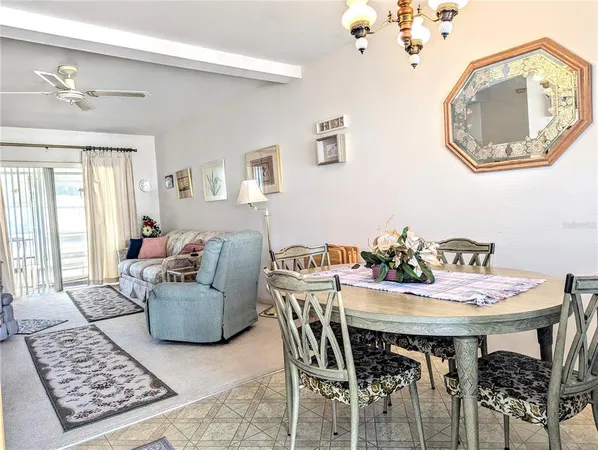 a view of a dining room with furniture and a chandelier