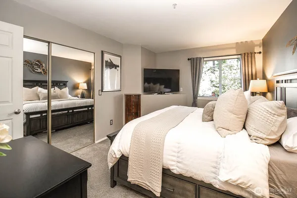 a bedroom with a bed and a couch