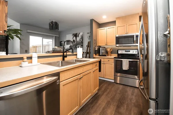 a kitchen with stainless steel appliances a sink and a refrigerator
