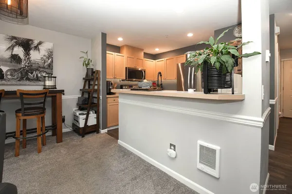 a kitchen with stainless steel appliances a sink and a refrigerator