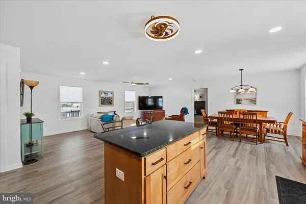 a kitchen with a sink appliances and wooden floor
