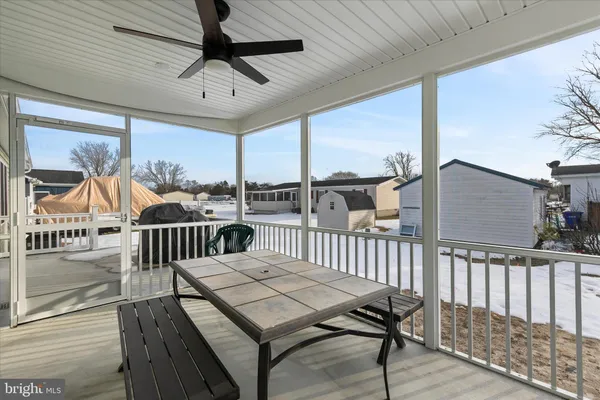 a view of a patio with a table chairs and deck