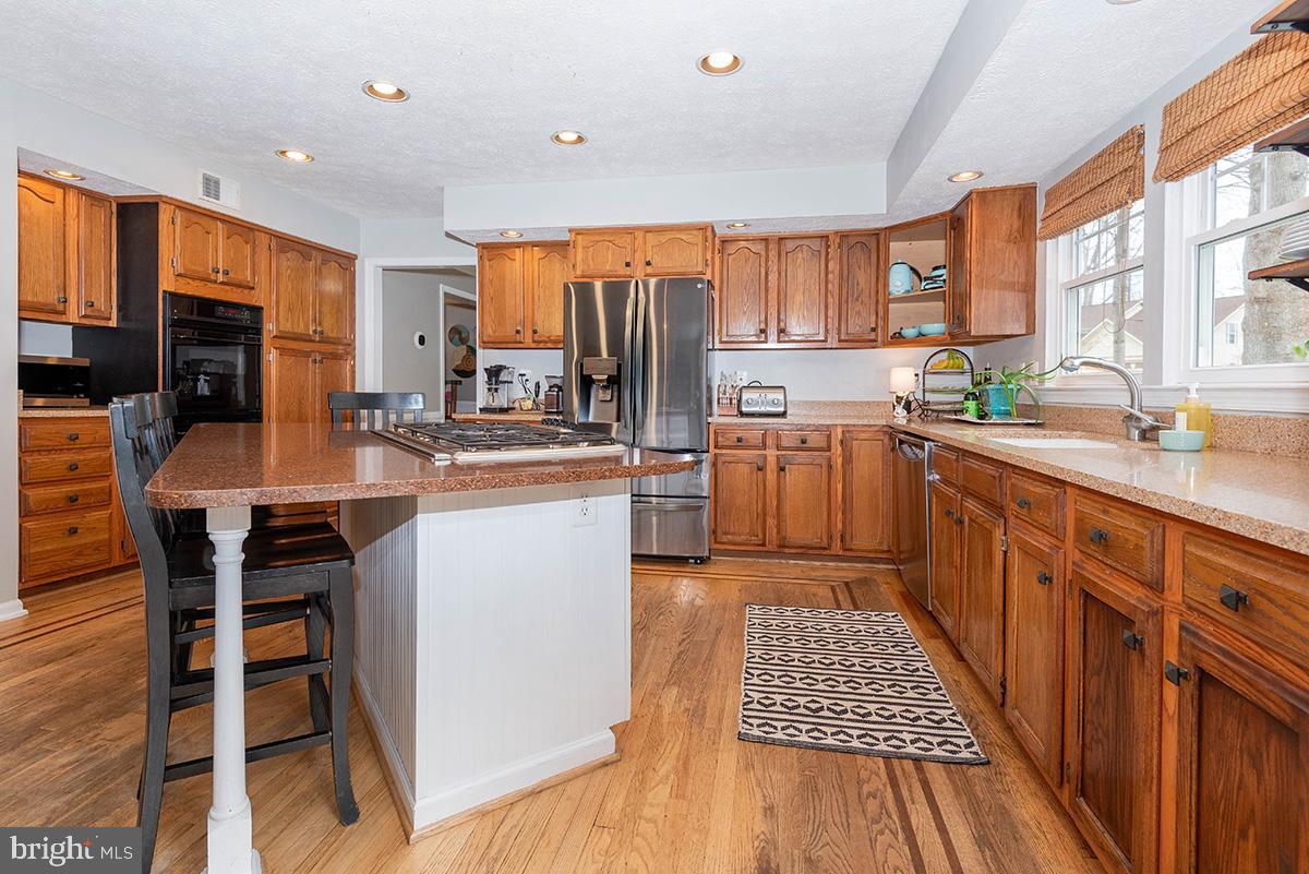 1665 Patrice Circle Crofton, MD 21114 - Photo 11 of 55 a kitchen with a sink a counter top space stainless steel appliances and windows