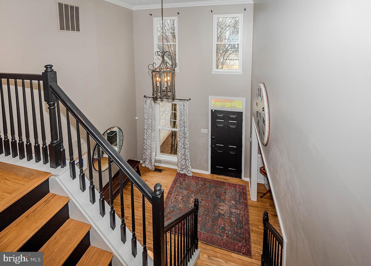 1665 Patrice Circle Crofton, MD 21114 - Photo 19 of 55 a view of staircase with lots of frames on wall and a window