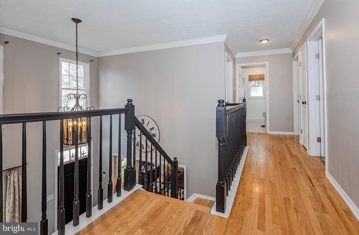 1665 Patrice Circle Crofton, MD 21114 - Photo 20 of 55 a view of a hallway with wooden floor and staircase