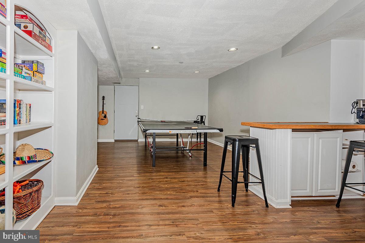 1665 Patrice Circle Crofton, MD 21114 - Photo 36 of 55 a hallway with a dining table chairs and wooden floor
