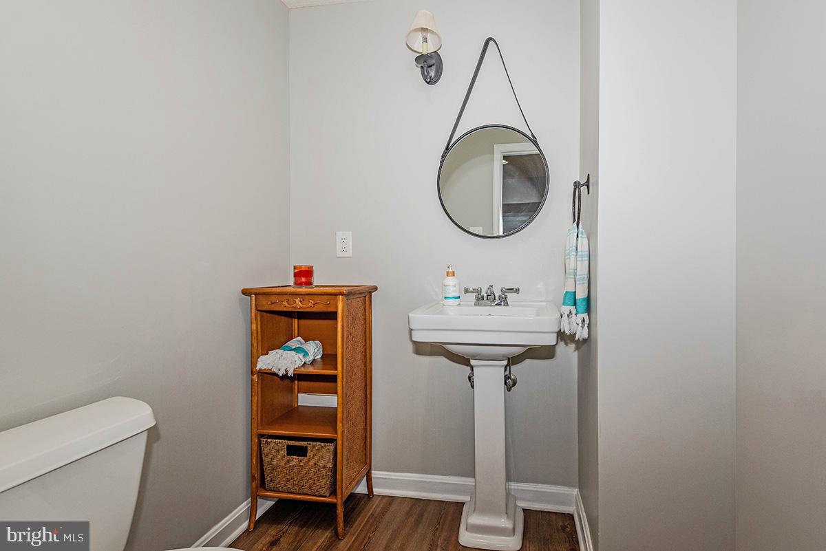 1665 Patrice Circle Crofton, MD 21114 - Photo 40 of 55 a bathroom with a sink a toilet and a mirror