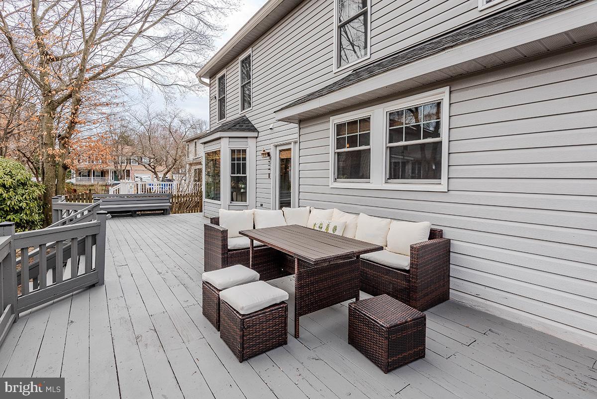 1665 Patrice Circle Crofton, MD 21114 - Photo 44 of 55 a view of a patio with couches and table and chairs with wooden floor and fence