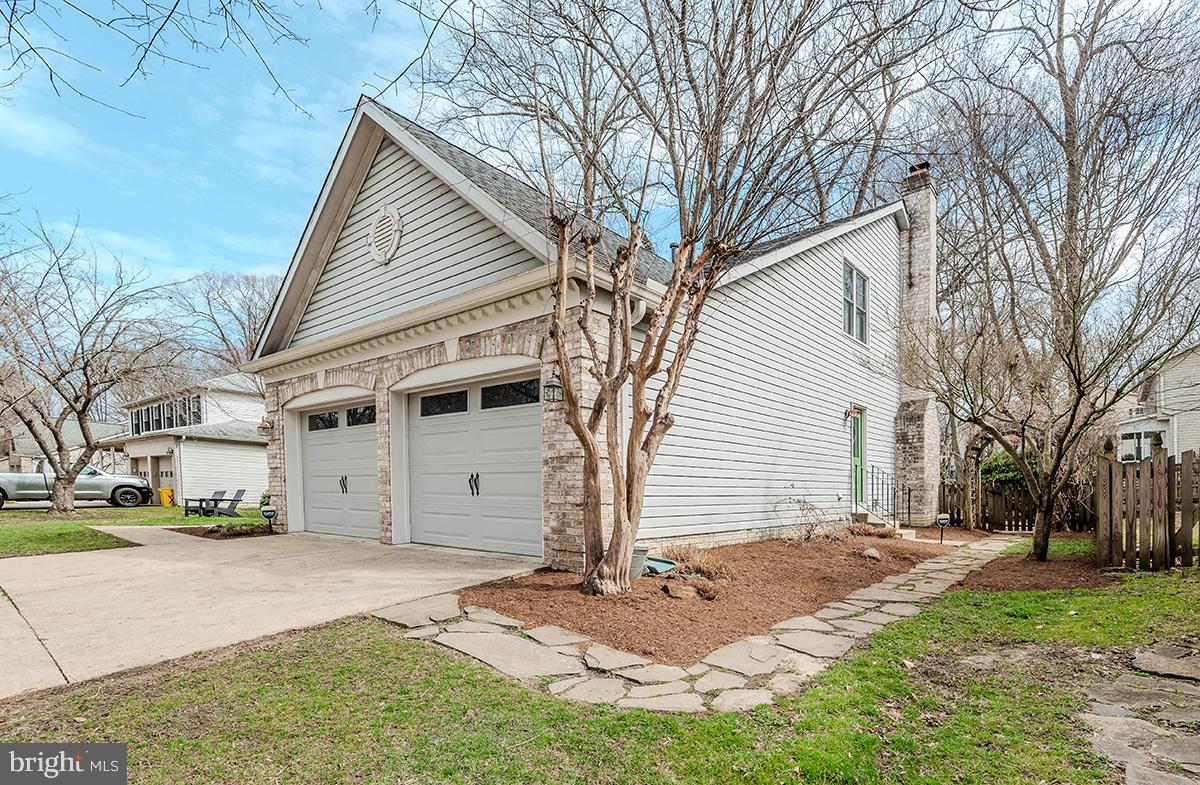 1665 Patrice Circle Crofton, MD 21114 - Photo 51 of 55 a view of a white house next to a yard with big trees