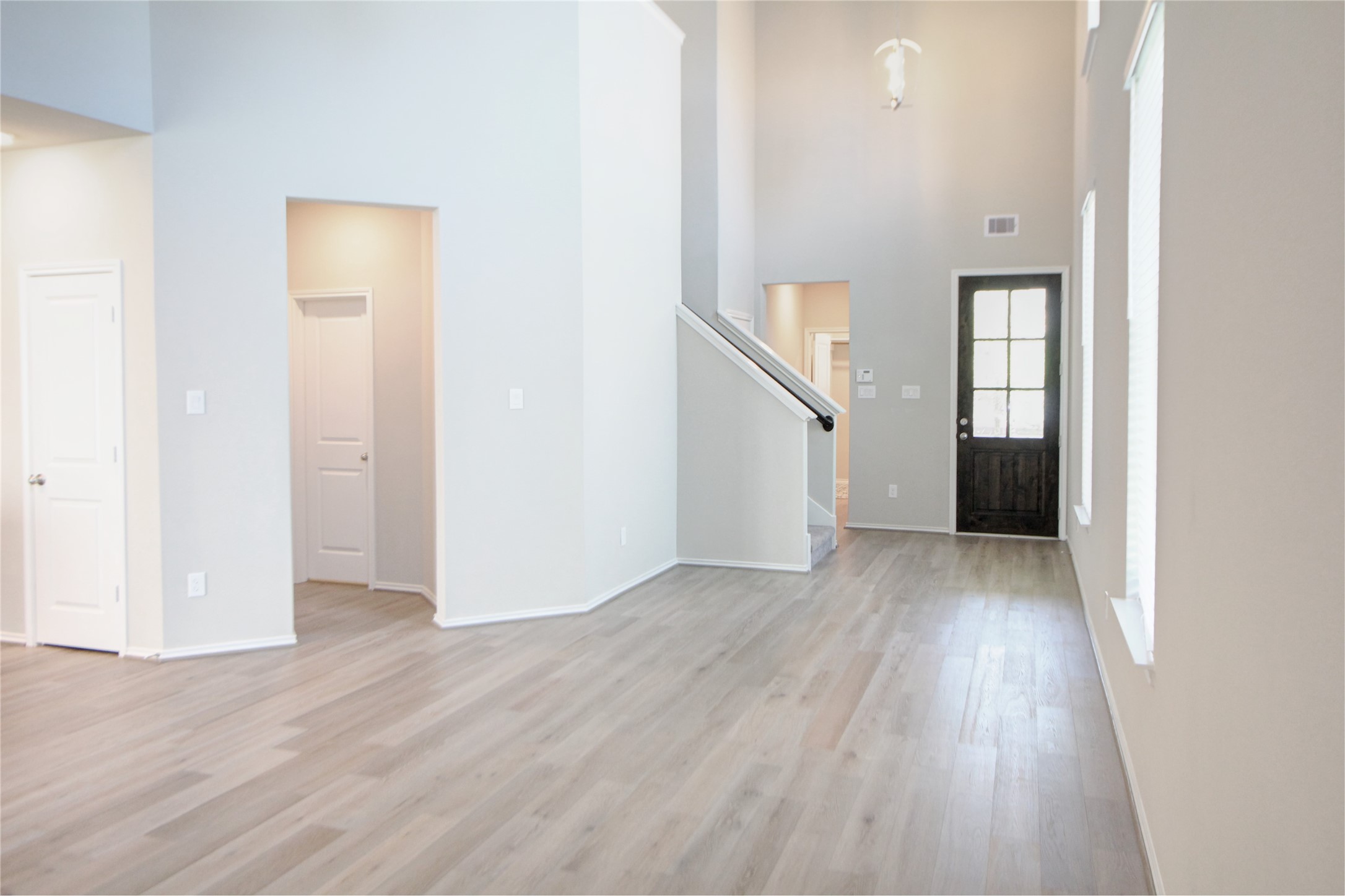 523 Timber Voyage Court Conroe, TX 77304 - Photo 3 of 20 an empty room with wooden floor and windows