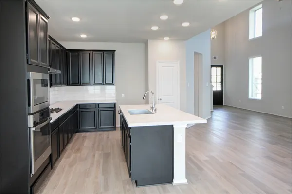a kitchen with a sink stainless steel appliances and cabinets