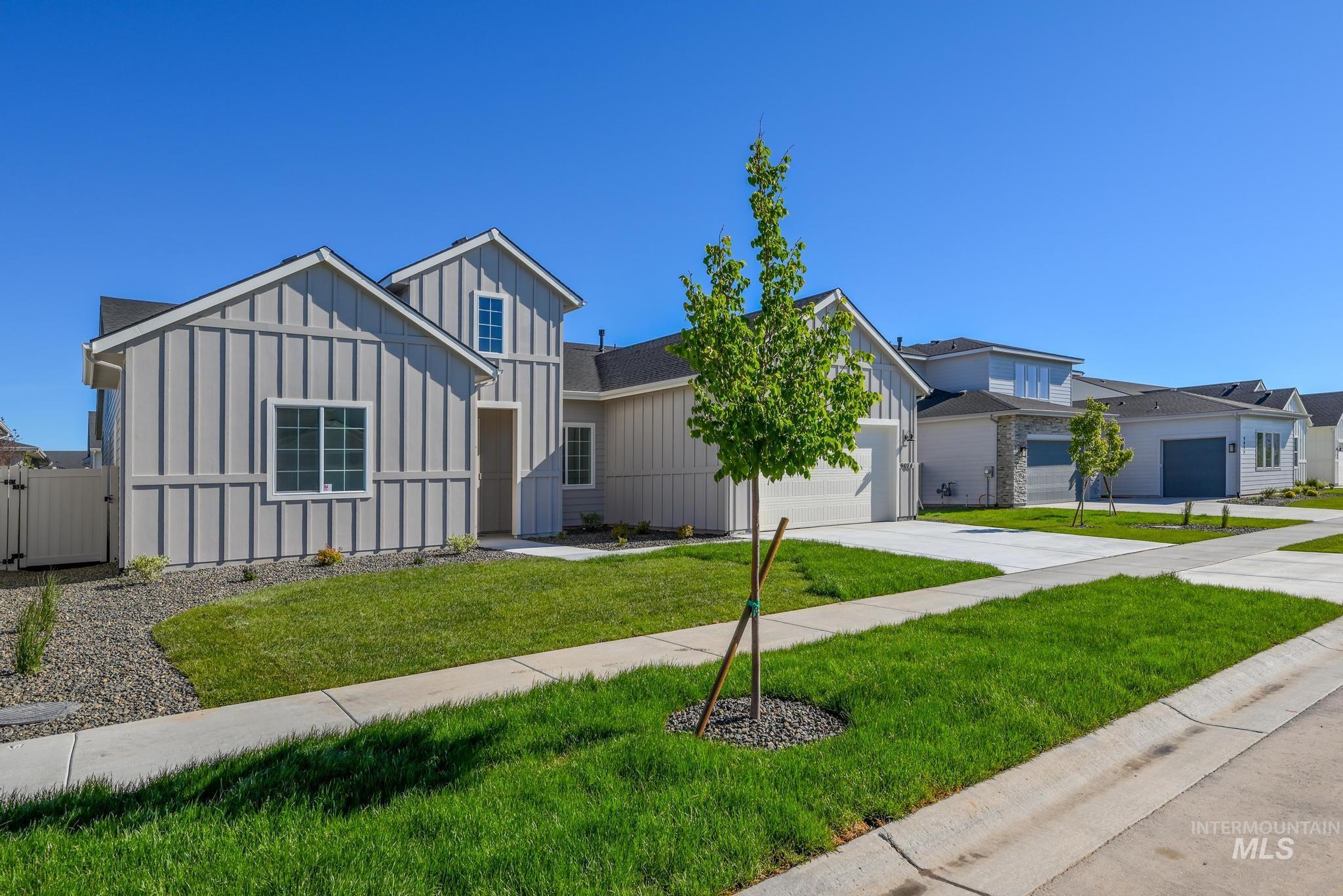 9074 West Moonglade Street Star, ID 83669 - Photo 2 of 40 Contemporary residence featuring board and batten siding, a prominent gable, and a white framed window