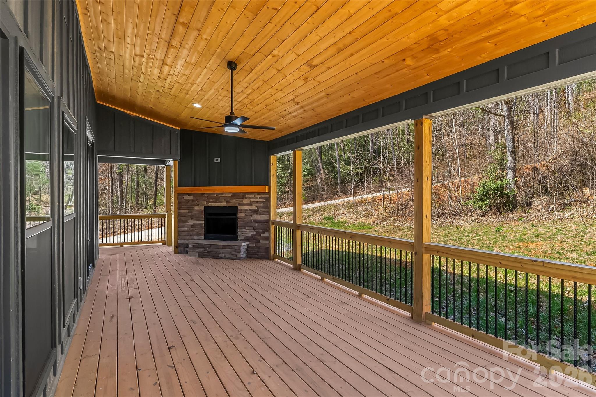 189 Clinchfield Gap Road Marion, NC 28752 - Photo 13 of 42 a view of an empty room with wooden floor fireplace and a window