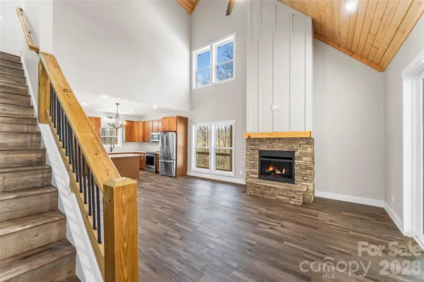 a view of a livingroom with wooden floor and a fireplace