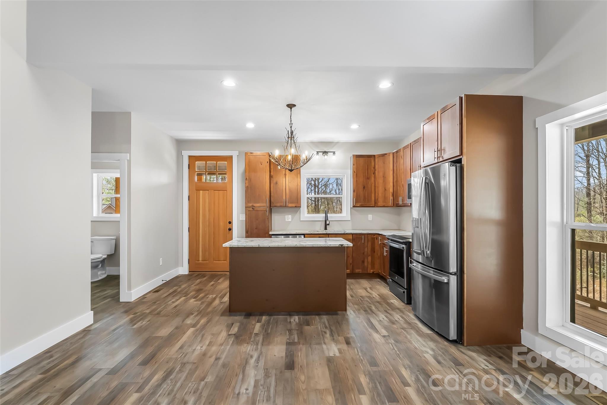 189 Clinchfield Gap Road Marion, NC 28752 - Photo 19 of 42 a kitchen with wooden floors and refrigerator