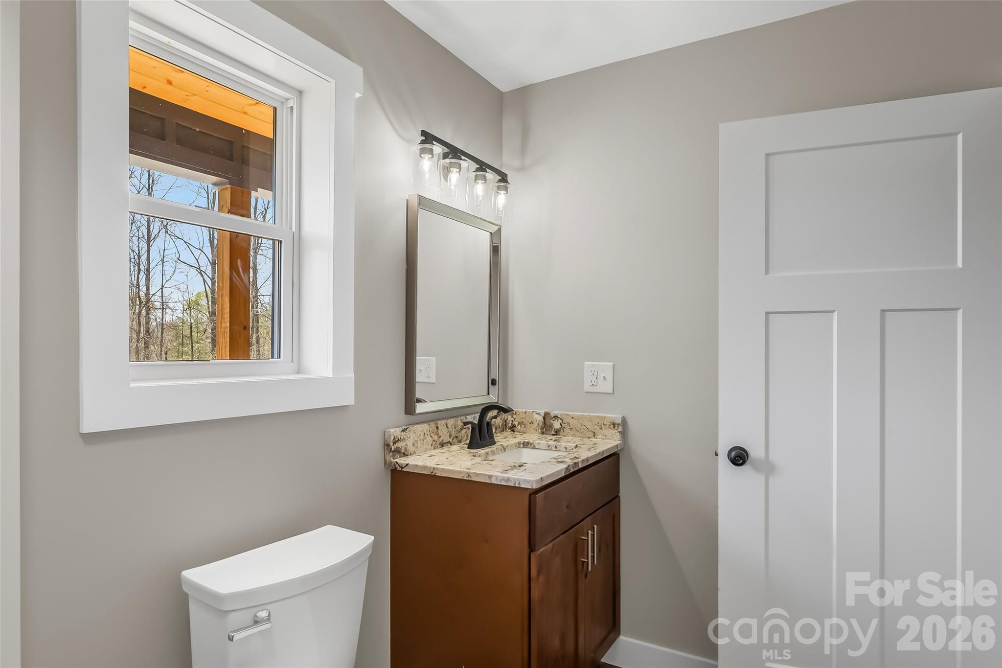189 Clinchfield Gap Road Marion, NC 28752 - Photo 22 of 42 a bathroom with a sink vanity and a mirror