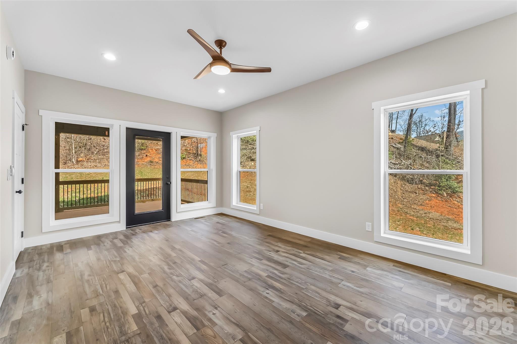 189 Clinchfield Gap Road Marion, NC 28752 - Photo 25 of 42 a view of an empty room with a window and wooden floor