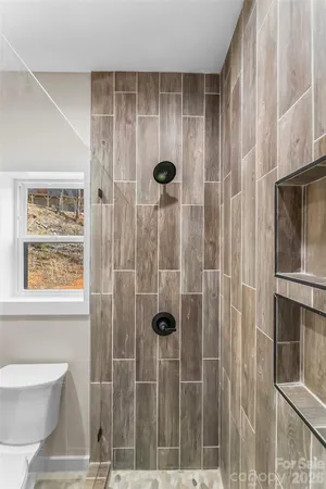 a bathroom with a shower and a toilet