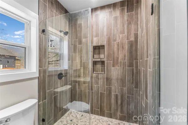 a bathroom with a shower and a toilet