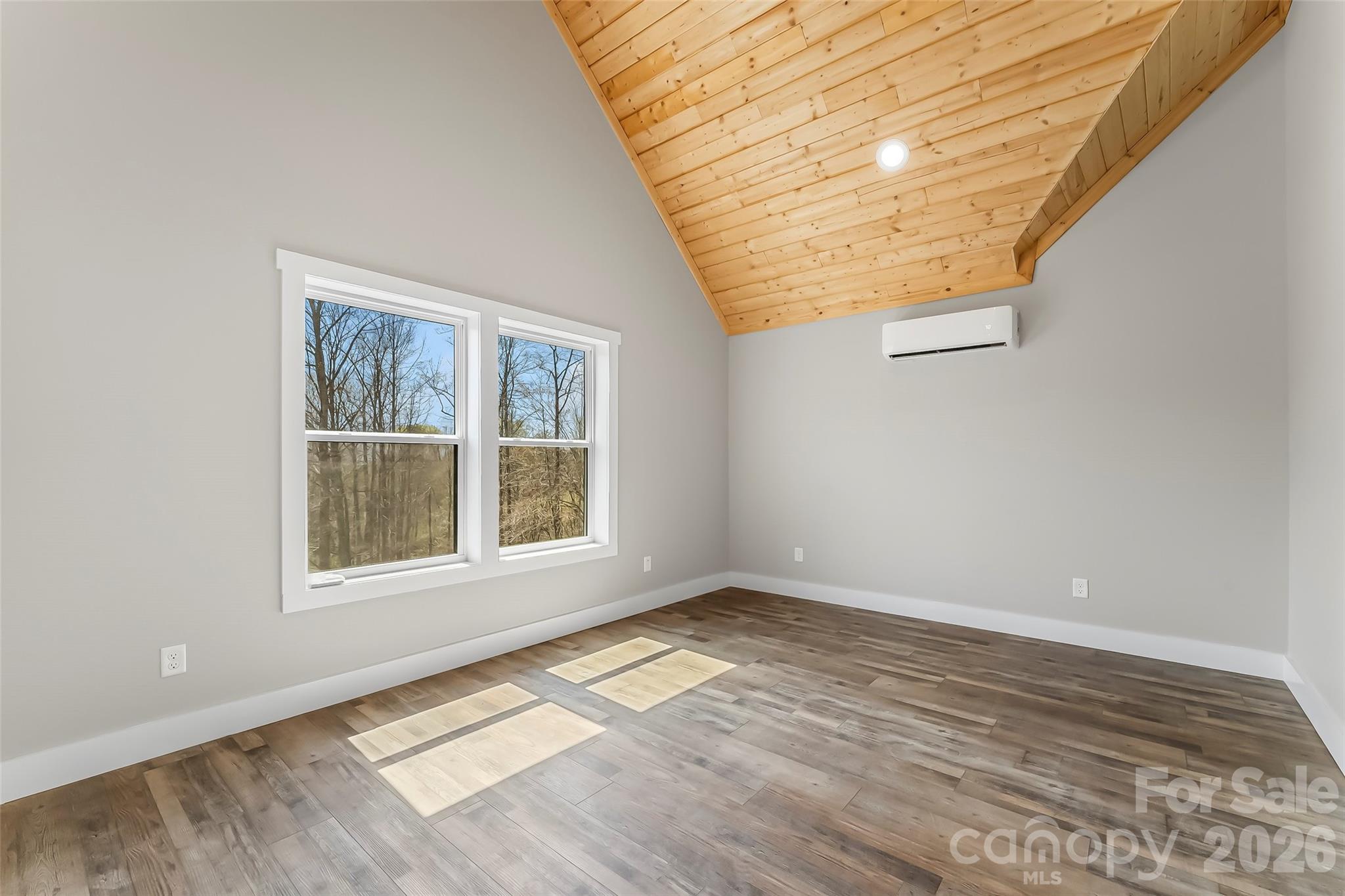 189 Clinchfield Gap Road Marion, NC 28752 - Photo 32 of 42 a view of an empty room with wooden floor and a window