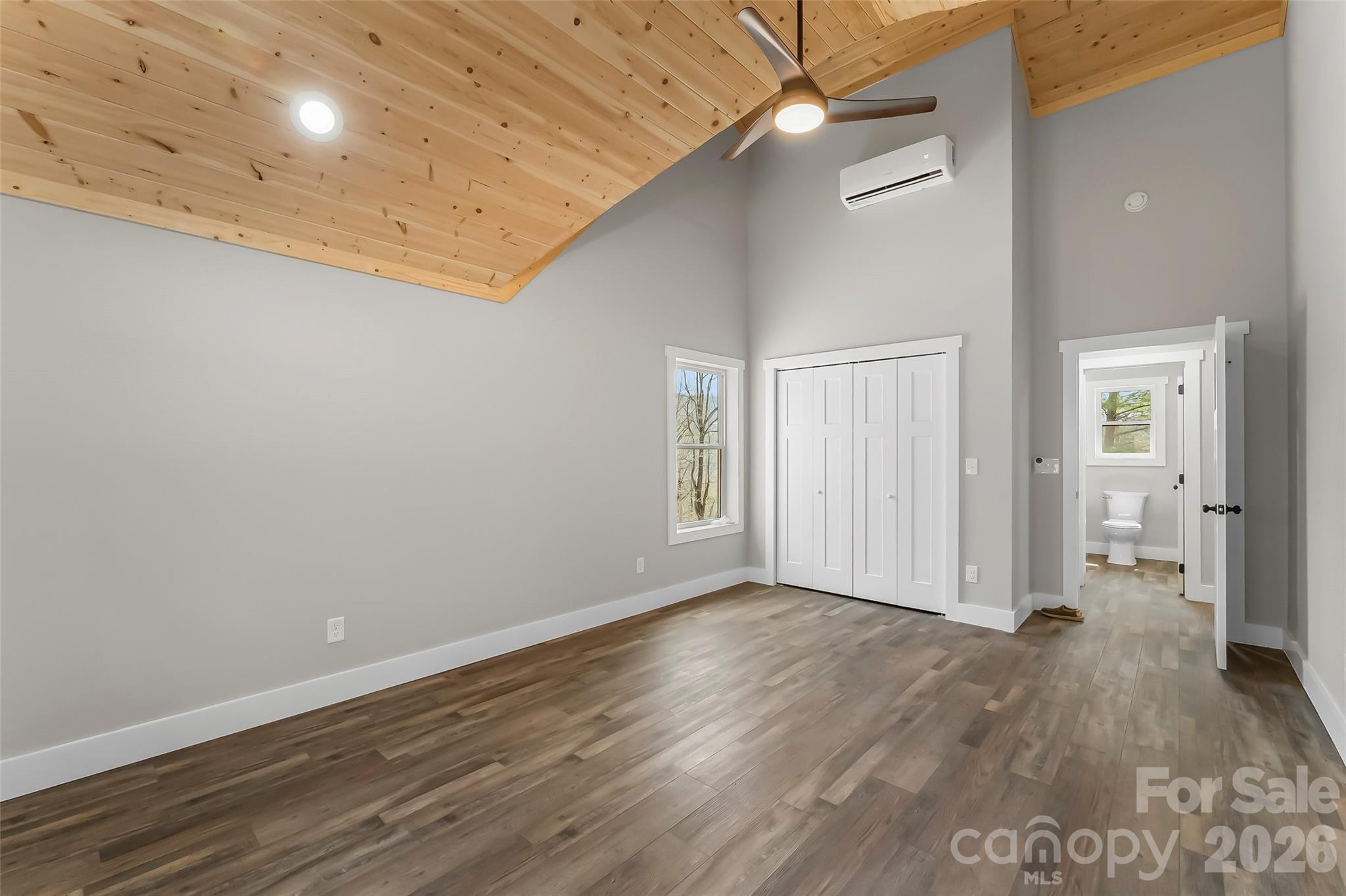 189 Clinchfield Gap Road Marion, NC 28752 - Photo 35 of 42 an empty room with wooden floor and windows