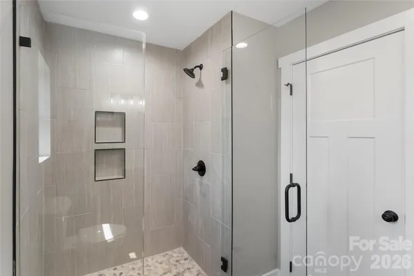a bathroom with a shower and a glass door