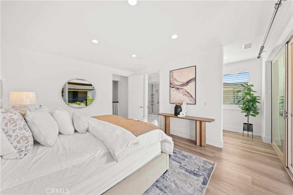 18 Windrow Road Tustin, CA 92782 - Photo 21 of 35 a bedroom with a large bed and a wooden floor