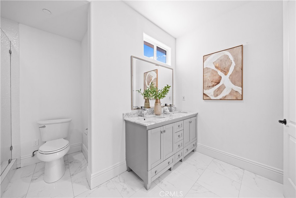 18 Windrow Road Tustin, CA 92782 - Photo 26 of 35 a bathroom with a toilet a sink and a mirror