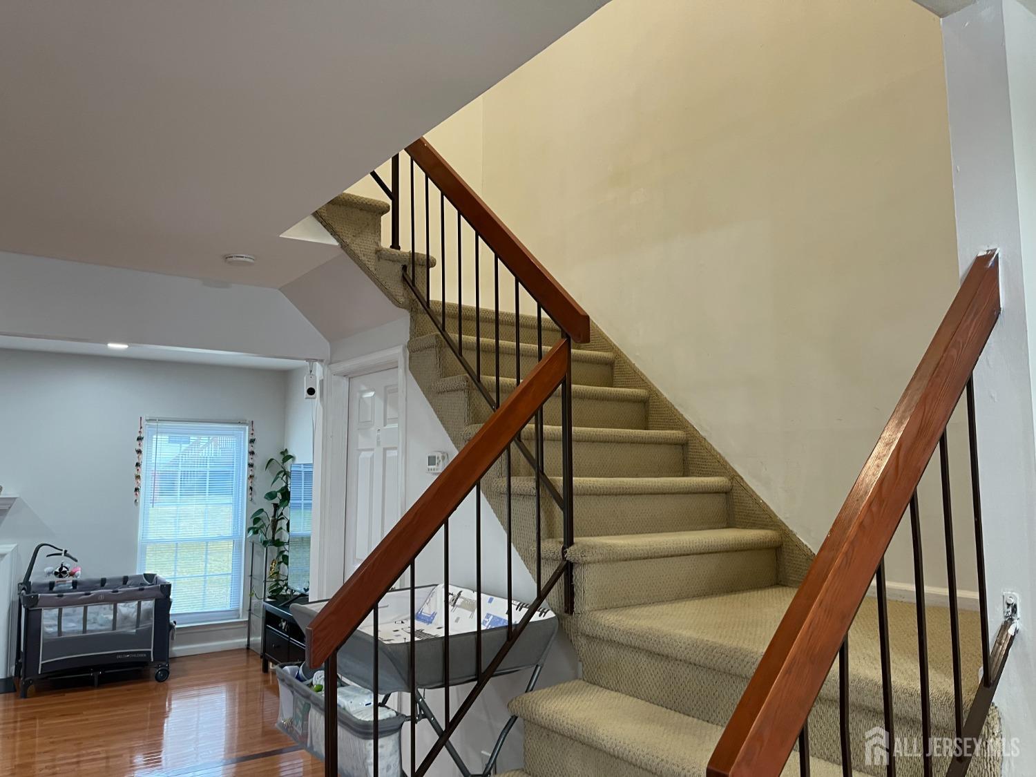 1505 Timber Oaks Road Edison, NJ 08820 - Photo 13 of 27 a view of entryway with wooden floor and stairs