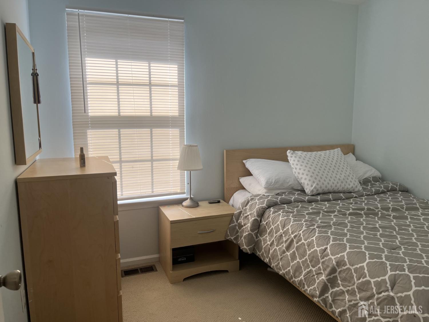 1505 Timber Oaks Road Edison, NJ 08820 - Photo 17 of 27 a bedroom with a bed and a window