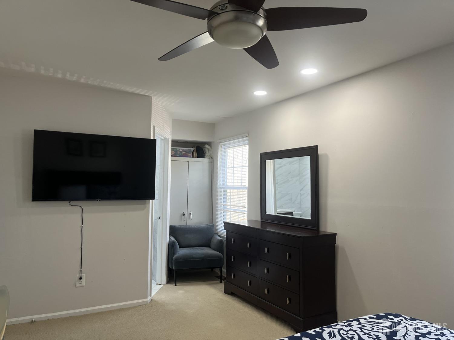 1505 Timber Oaks Road Edison, NJ 08820 - Photo 19 of 27 a living room with furniture and a flat screen tv