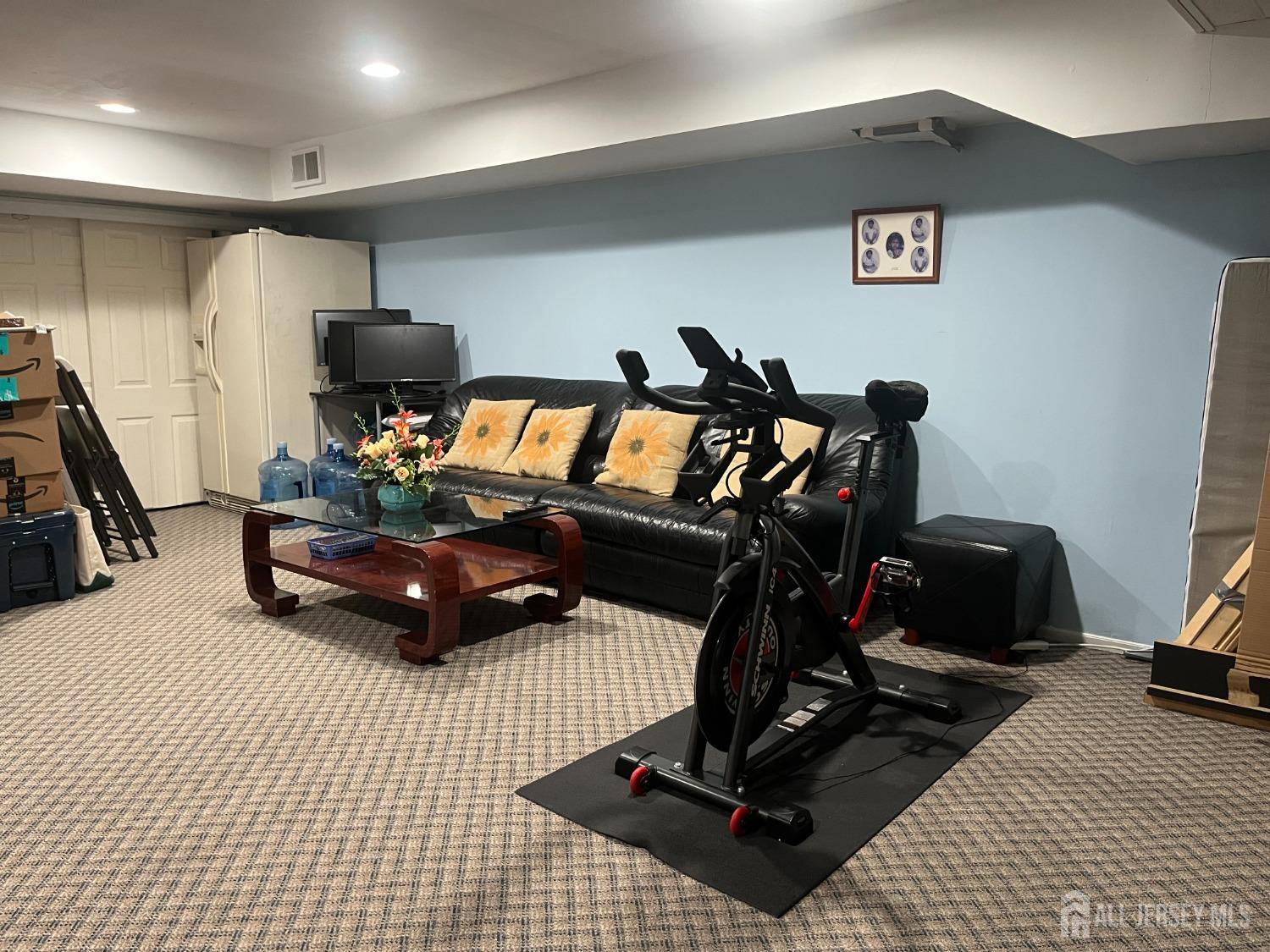1505 Timber Oaks Road Edison, NJ 08820 - Photo 24 of 27 a room with gym equipment and a large mirror
