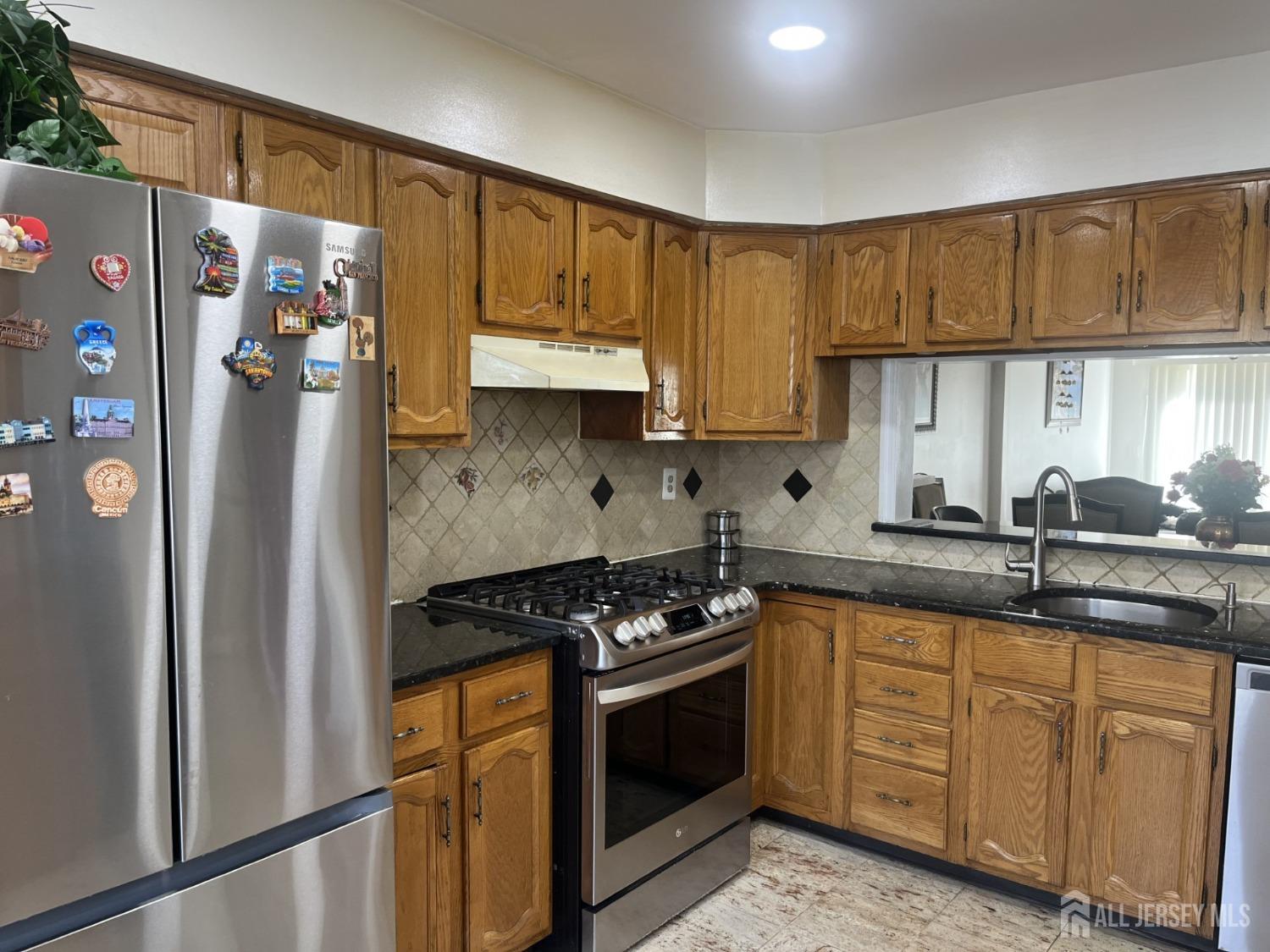 1505 Timber Oaks Road Edison, NJ 08820 - Photo 6 of 27 a kitchen with stainless steel appliances granite countertop a refrigerator sink and cabinets