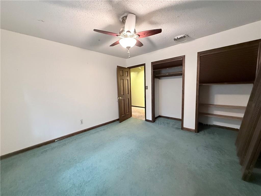 3033 Riviera Drive Conyers, GA 30012 - Photo 24 of 79 a view of an empty room with a fireplace and a ceiling fan