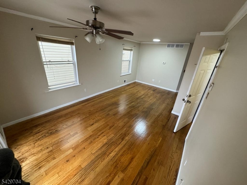821 Anna Street Elizabeth, NJ 07201 - Photo 11 of 11 wooden floor in an empty room with a window