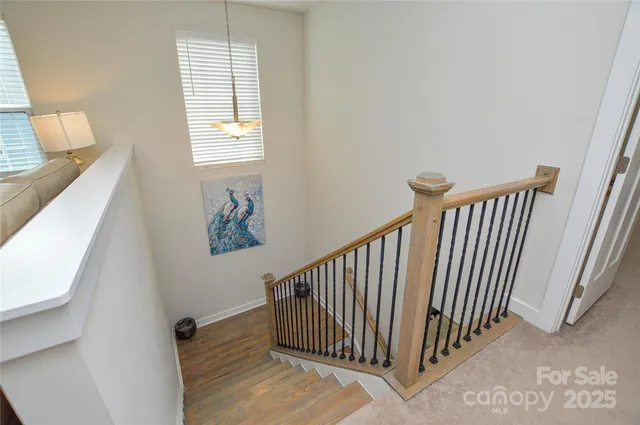 a bedroom with a bed and large windows