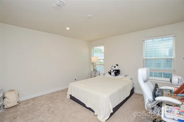 a view of an house with backyard and trees
