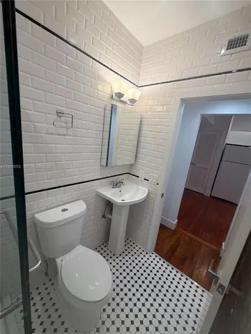 a bathroom with a toilet a sink and shower